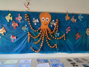 a child's drawing on a blue wall