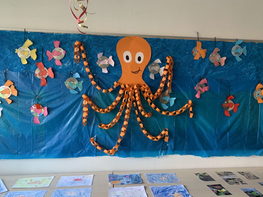 a child's drawing on a blue wall